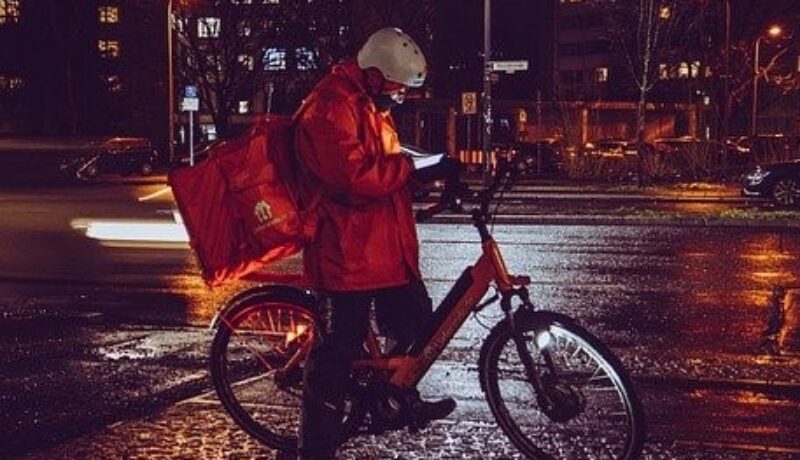 against the background of the evening city, a guy on a bicycle